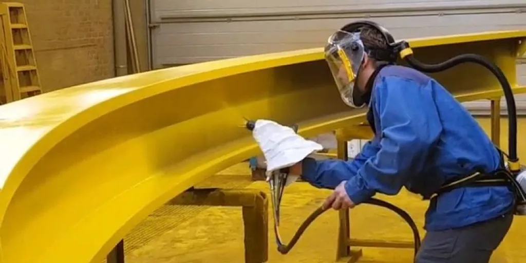 professional-steel-siding-painting-yellow-curved