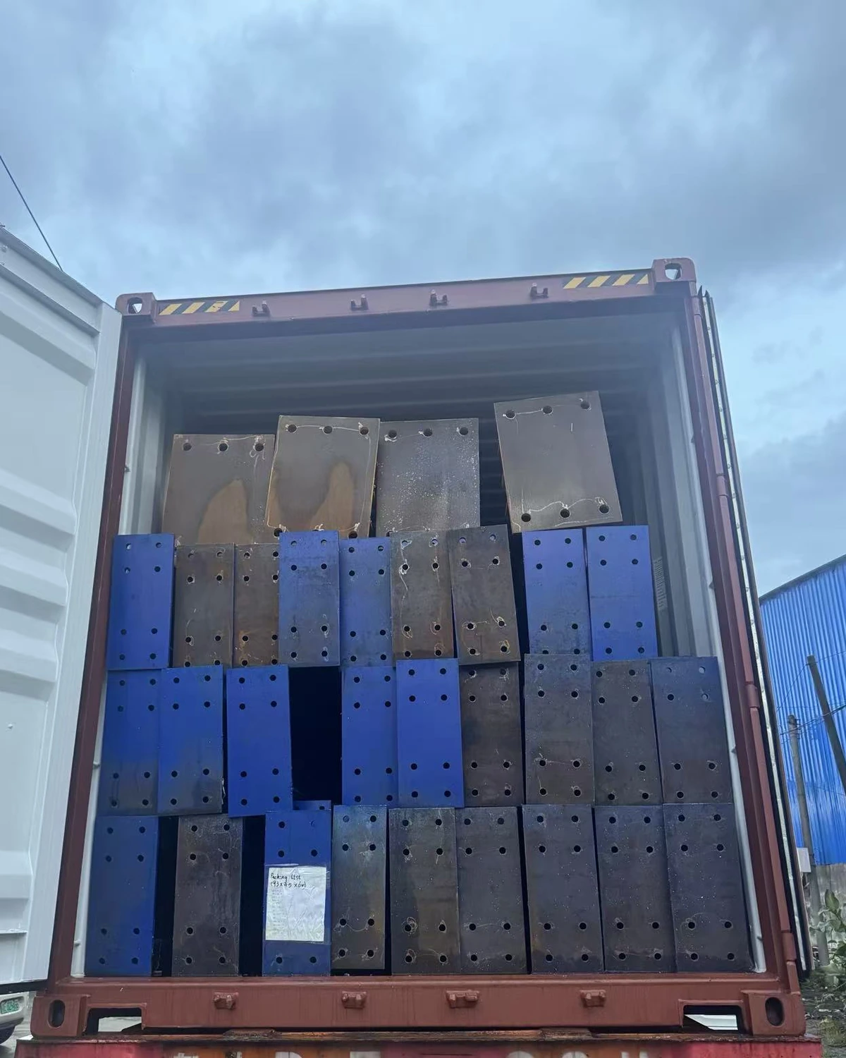 Steel building components loaded into a shipping container for export