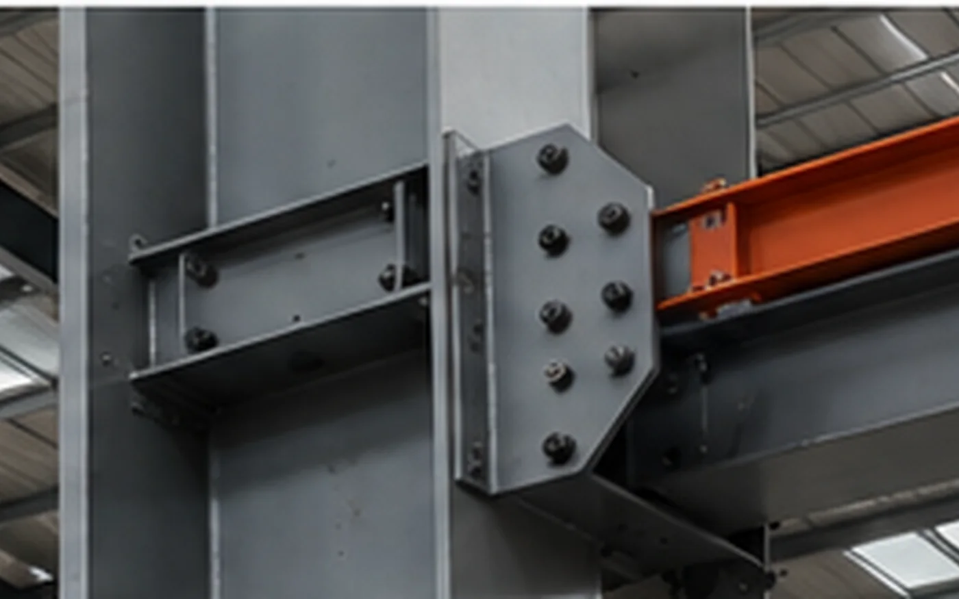 Crane runway support and structural column interface in an industrial steel building