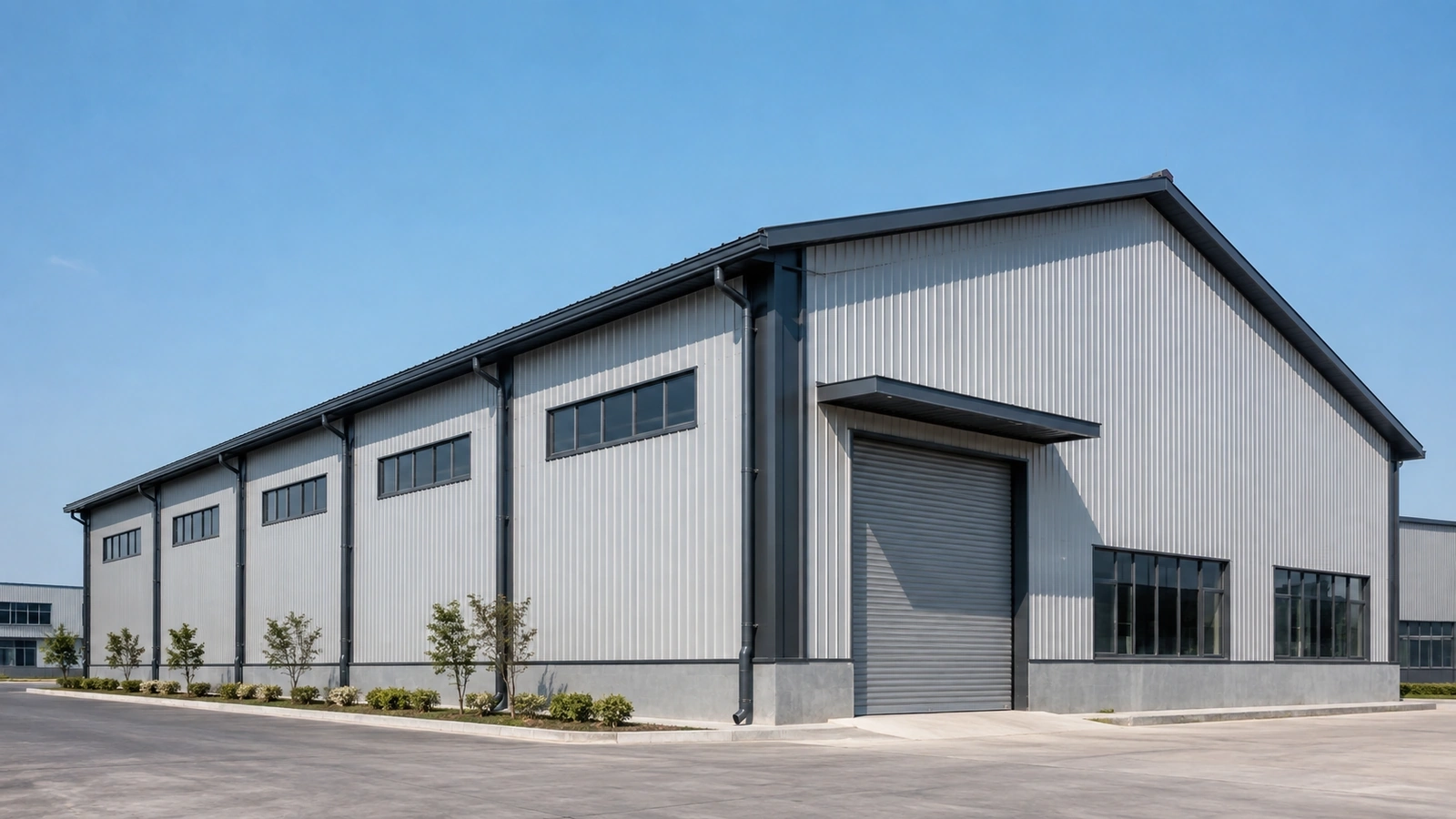 steel warehouse exterior showing gable roof slope with gutters and downspouts